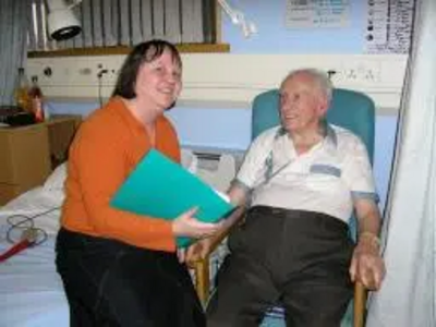 Jacquie with elderly patient in hospital